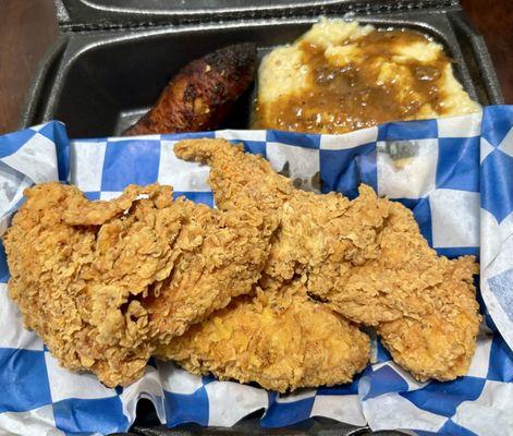 Fried chicken tenders, cheesy grits & gravy, and plantain