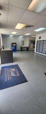 Box lobby with tables and a parcel drop off box.