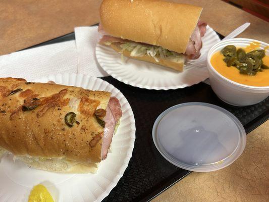 Italian sub on left, Sid's Special on right. Also we got tortilla chips and cheese sauce with jalapeños.