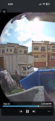 XL furniture covered in plastic on ground.