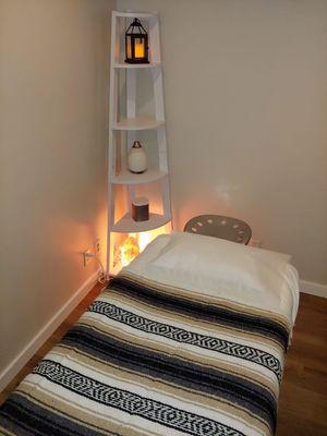 Treatment room with heated massage bed