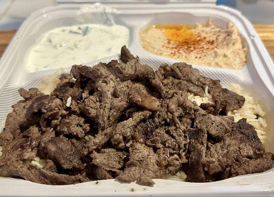 Yummy beef shawarma, rice pilaf, hummus, and tzatziki