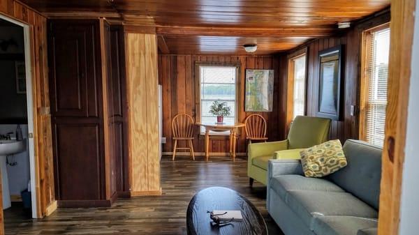 Living room and dining area with water views