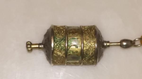 Pendant Prayer Wheel showing poor condition. Tarnish and green corrosion.