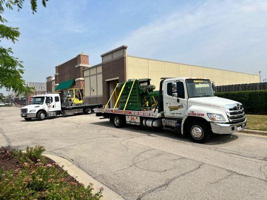 moving a baler with trucks 02 and 05 along with our forklift.