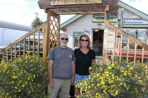 Owners, Ed and Lauren in front of Rocky Mountain Interiors Picture Framing