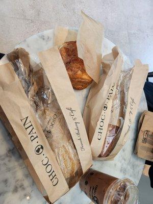 Ham and Swiss sandwich, spicy tuna sandwich, Choco Pain (chocolate croissant), and iced mocha