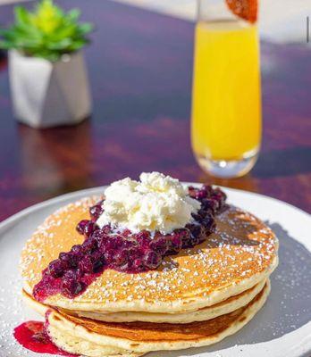 Cakes served with a triple berry compote.