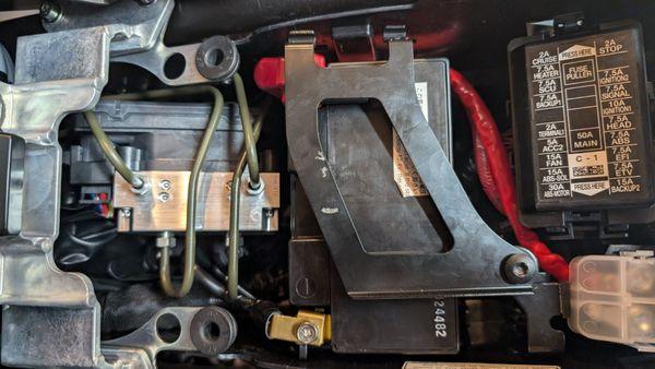 Notice the battery hold down directly over the positive terminal, and not connected on the top. This is how my bike left their dealership.