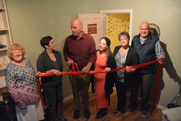 Cutting the ribbon to celebrate the opening of Be Well Studio!