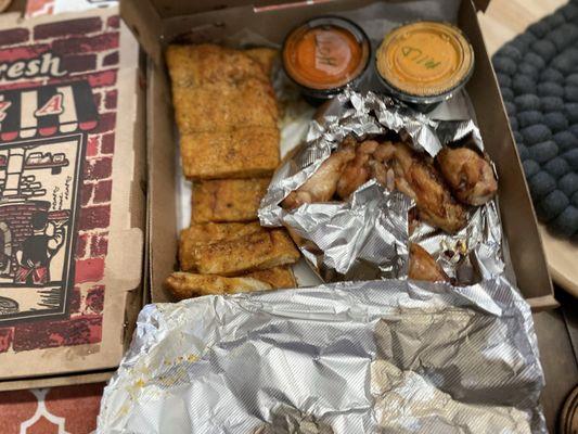 Garlic bread and chicken with mild and hot buffalo sauce.