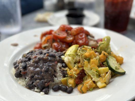 Grouper Provencal, covered in grape tomatoes and seasoning. Sides are black beans over rice, plus veggie medley. Delicious.