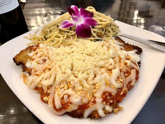Veal Parmiggiano with side of Aglio Olio pasta