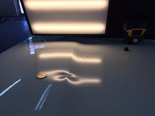 Nasty dent on a Honda Pilot hood before.