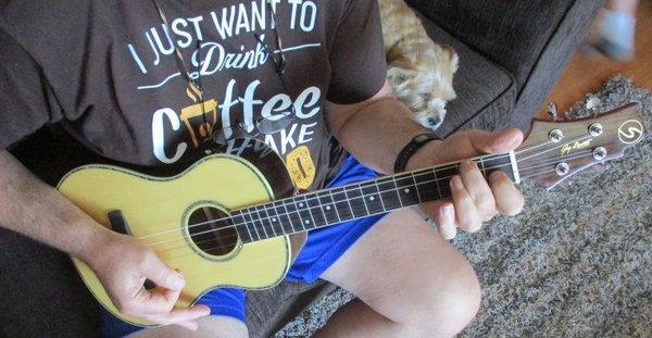 Samick Greg Bennett designed Baritone Ukulele; a bored canine; and, a blurry ankle...