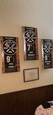 Full of trophies and plaques from BBQ competitions.