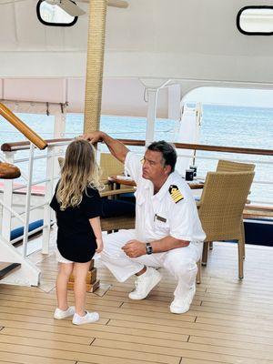 Captain Charles talking to the youngest guest, on her level!