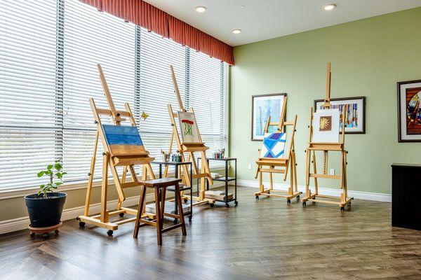Tech Ridge Oaks | Austin, TX | Four easels with paintings in progress in the Art room