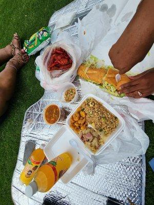 Shrimp po-boy, gumbo, crawfish, shrimp fried rice, cabbage, fried shrimp with a pineapple Big Shot (cold drink) on the side