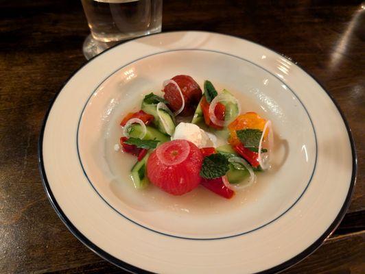 Jewel Box tomatoes, cucumber, and yellow Jimmy Nardello peppers in tomato water with feta gelato and mint