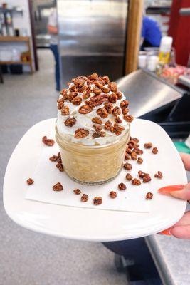 Caramel pudding with whipped cream and candied pecans