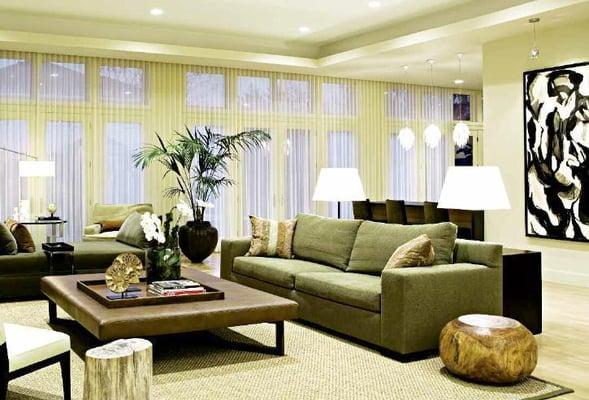 View of Living Room looking out to the full glass expanse viewing the rear deck with firepit.