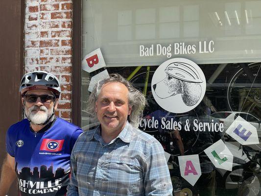The owner on the right with my cycling buddy on left in front of the shop
