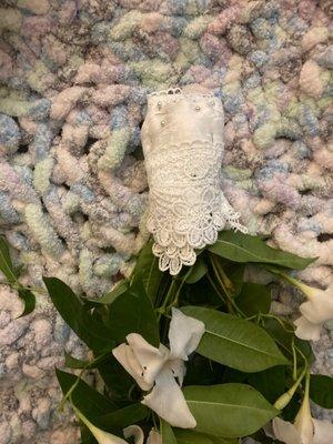 A hand wrapped bridal flower bouquet with pearl topped pins.