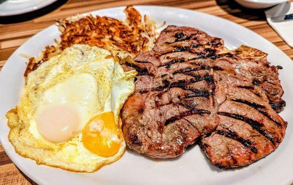 Porterhouse steak eggs and hash browns and sourdough toast
