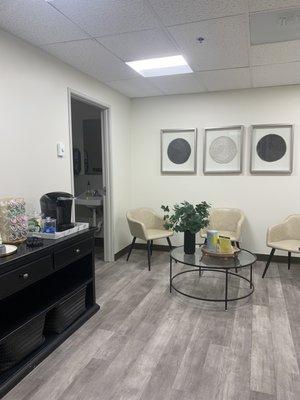 Waiting area with private bathroom and complimentary fully-stocked coffee and tea cart