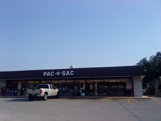 Pac-N-Sac storefront, with the iconic Buda water tower behind it.