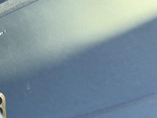 Teeny tiny mark just to the right of the reflection of the phone is all that's visible of the patched pit.