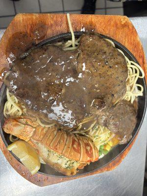 Combination lobster tail and ribeye steak dinner