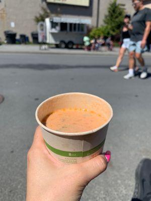 Cup of Sitka Salmon Bisque with the wagon behind