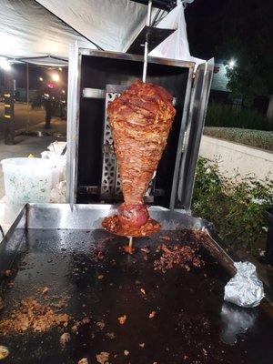 The Al Pastor (Shephard style) meat is roasting on the mandatory "Trompo" named after the spinning top toy. Delicious tacos !
