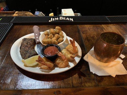 Steak and shrimp with a moscow mule.