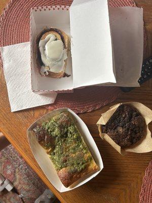 Pesto pea focaccia (bottom left), chocolate zucchini muffin (bottom right), cinnamon roll (top)