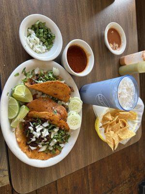 Birria tacos with soup/dip,horchata,side of onions and cilantro (gratis),fresh tortilla chips and house hot sauces.