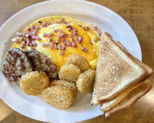 Omelette, turkey sausage, potato pancakes, and toast