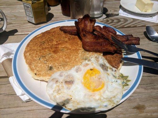 Blueberry pancakes, bacon and egg