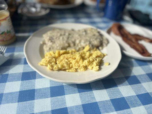 Biscuits and sausage gravy with a side of bacon