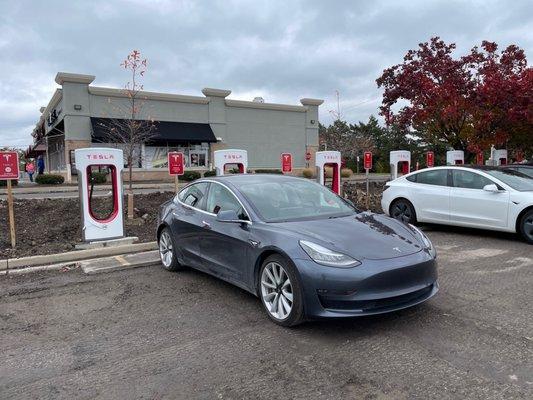 Tesla supercharger. Parking lot re-paving but still open