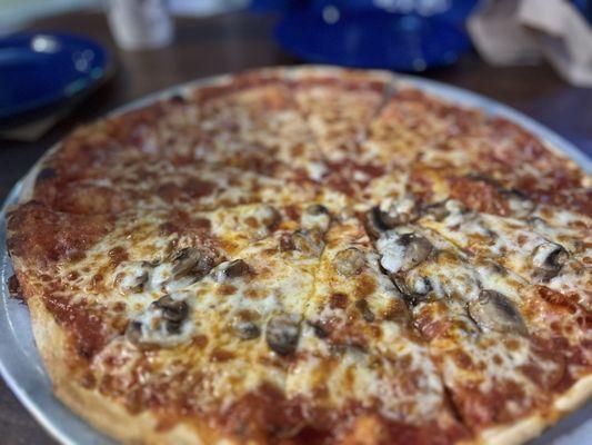 Half cheese half pepperoni and mushroom thin crust pizza