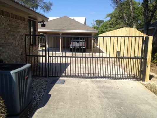 Custom Welded, Powder Coated Aluminum Gate with electronic operator, keypad, and remotes.8ft Wood Board on Board fence, taper...