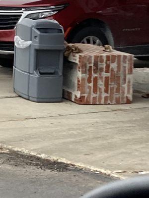 This thing protecting the western-most pump has been laying here for weeks. Try not to wreck your car driving around this pump