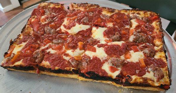 Detroit style pizza w/ sausage & roasted red pepper.