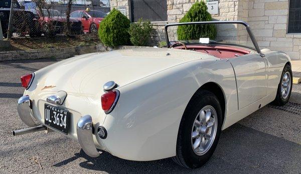 1960 Austin-Healey Sprite looks perfect after dent repair and paint on rear quarter panel.