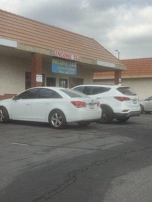 Crazy lady standing behind the white SUV looks like a bum.