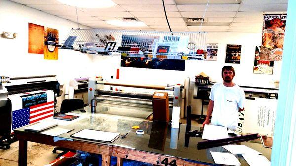 Dennis with our Mimaki printers, cutter, and laminator