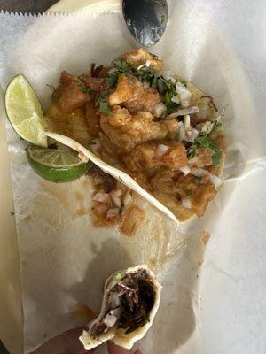 Two breakfast tacos - chicharron with beans and cilantro w/onion & barbacoa with beans and cilantro w/onion on flour tortillas